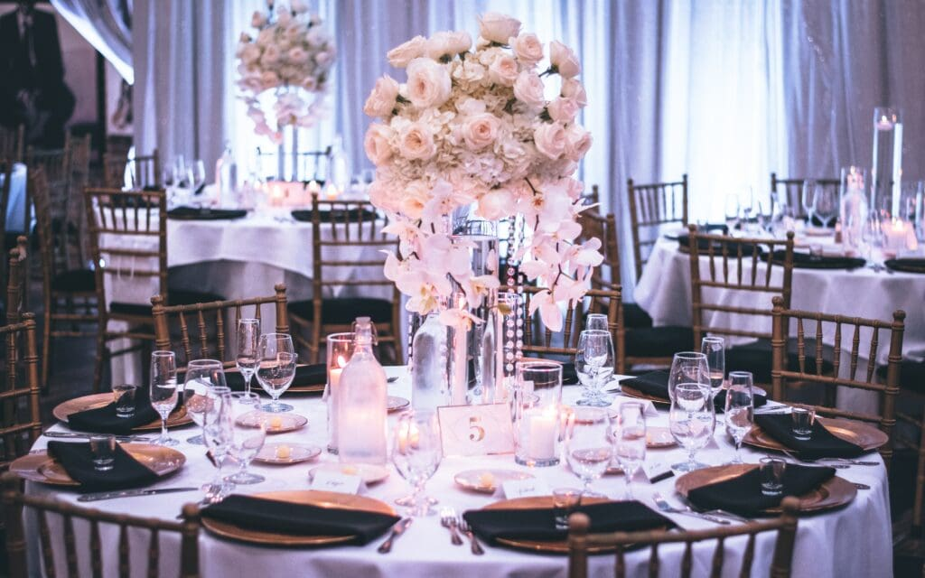 Elegant event hall with floral centerpieces and set tables